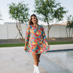 Front view of Viola Mini Dress with tiered skirt, tie front detail, and ruffled 3/4 sleeves.