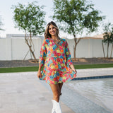 Front view of Viola Mini Dress with tiered skirt, tie front detail, and ruffled 3/4 sleeves.
