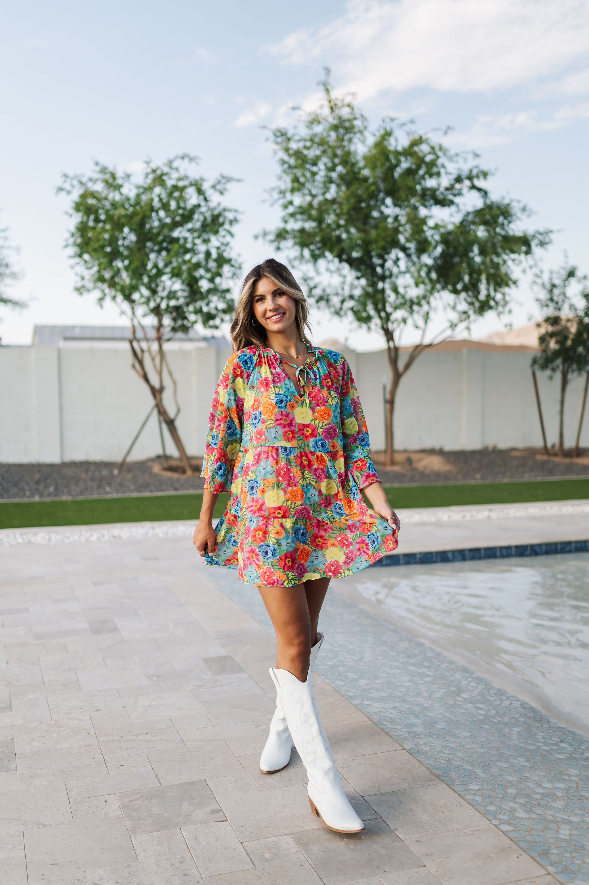 Front view of Viola Mini Dress with tiered skirt, tie front detail, and ruffled 3/4 sleeves.