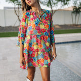 Front view of Viola Mini Dress with tiered skirt, tie front detail, and ruffled 3/4 sleeves.