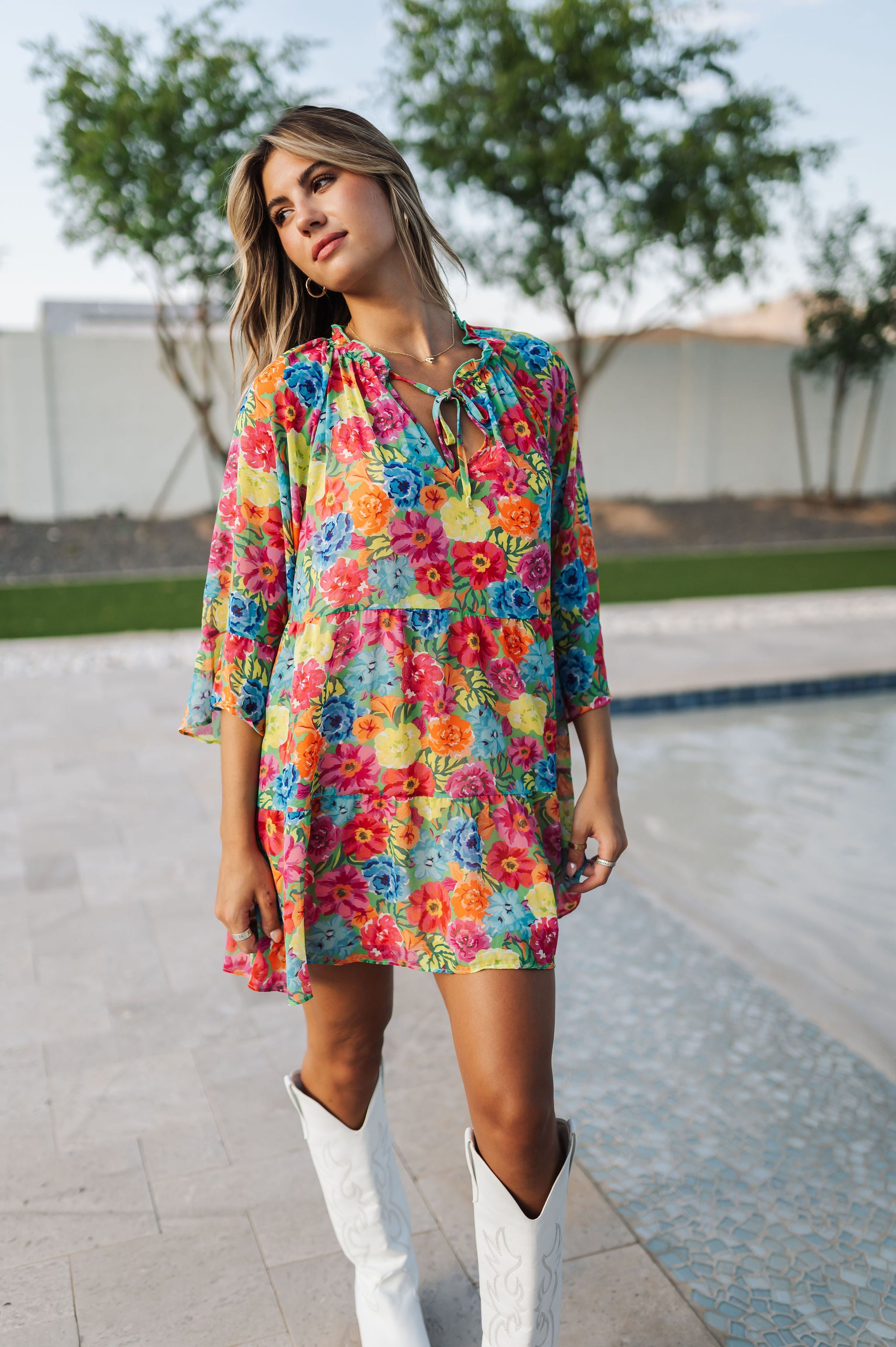 Front view of Viola Mini Dress with tiered skirt, tie front detail, and ruffled 3/4 sleeves.