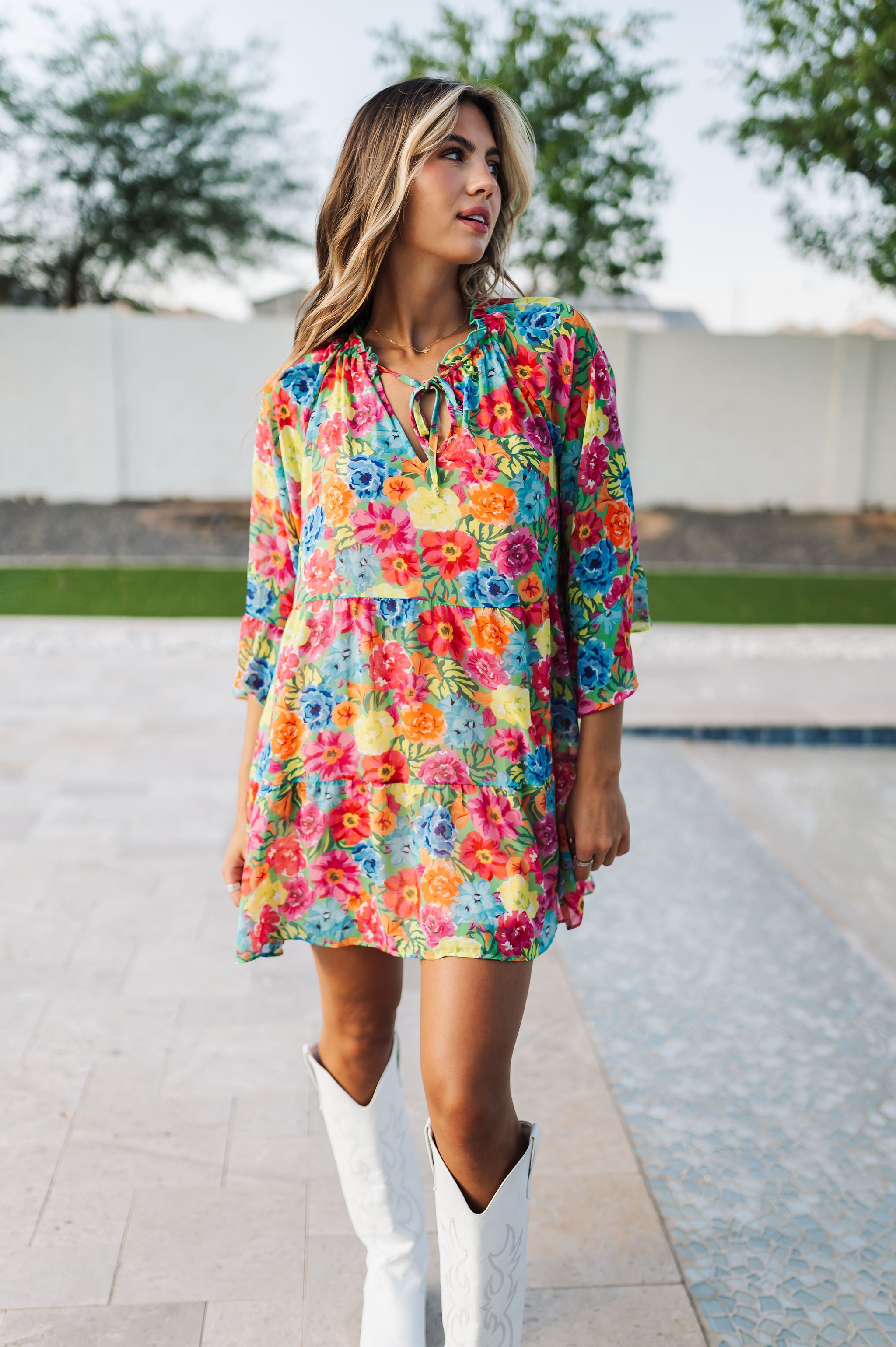 Front view of Viola Mini Dress with tiered skirt, tie front detail, and ruffled 3/4 sleeves.