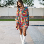 Front view of Viola Mini Dress with tiered skirt, tie front detail, and ruffled 3/4 sleeves.