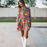 Front view of Viola Mini Dress with tiered skirt, tie front detail, and ruffled 3/4 sleeves.