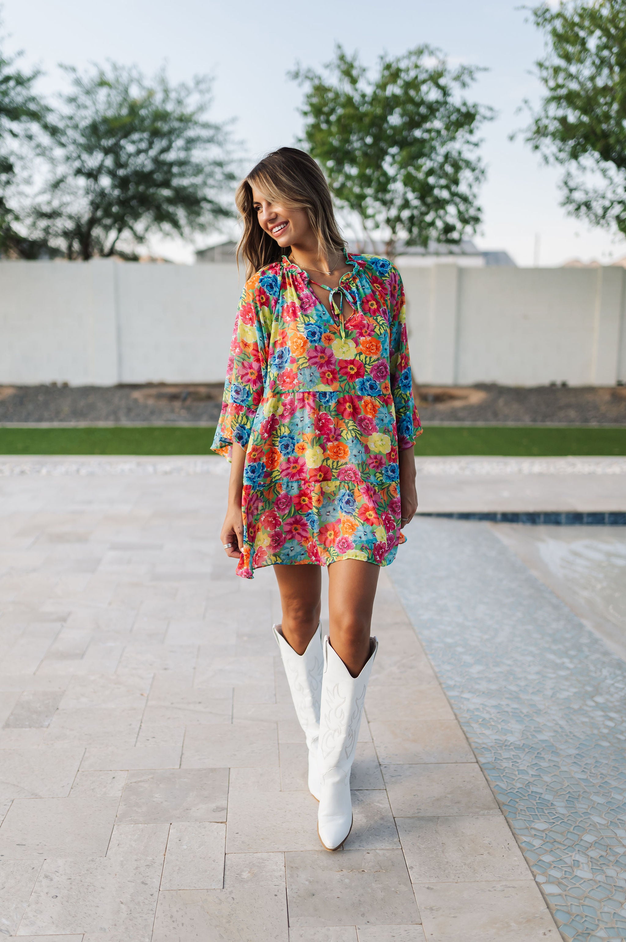 Front view of Viola Mini Dress with tiered skirt, tie front detail, and ruffled 3/4 sleeves.