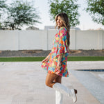 Side view of Viola Mini Dress with tiered skirt and ruffled 3/4 sleeves.