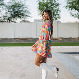 Side view of Viola Mini Dress with tiered skirt and ruffled 3/4 sleeves.