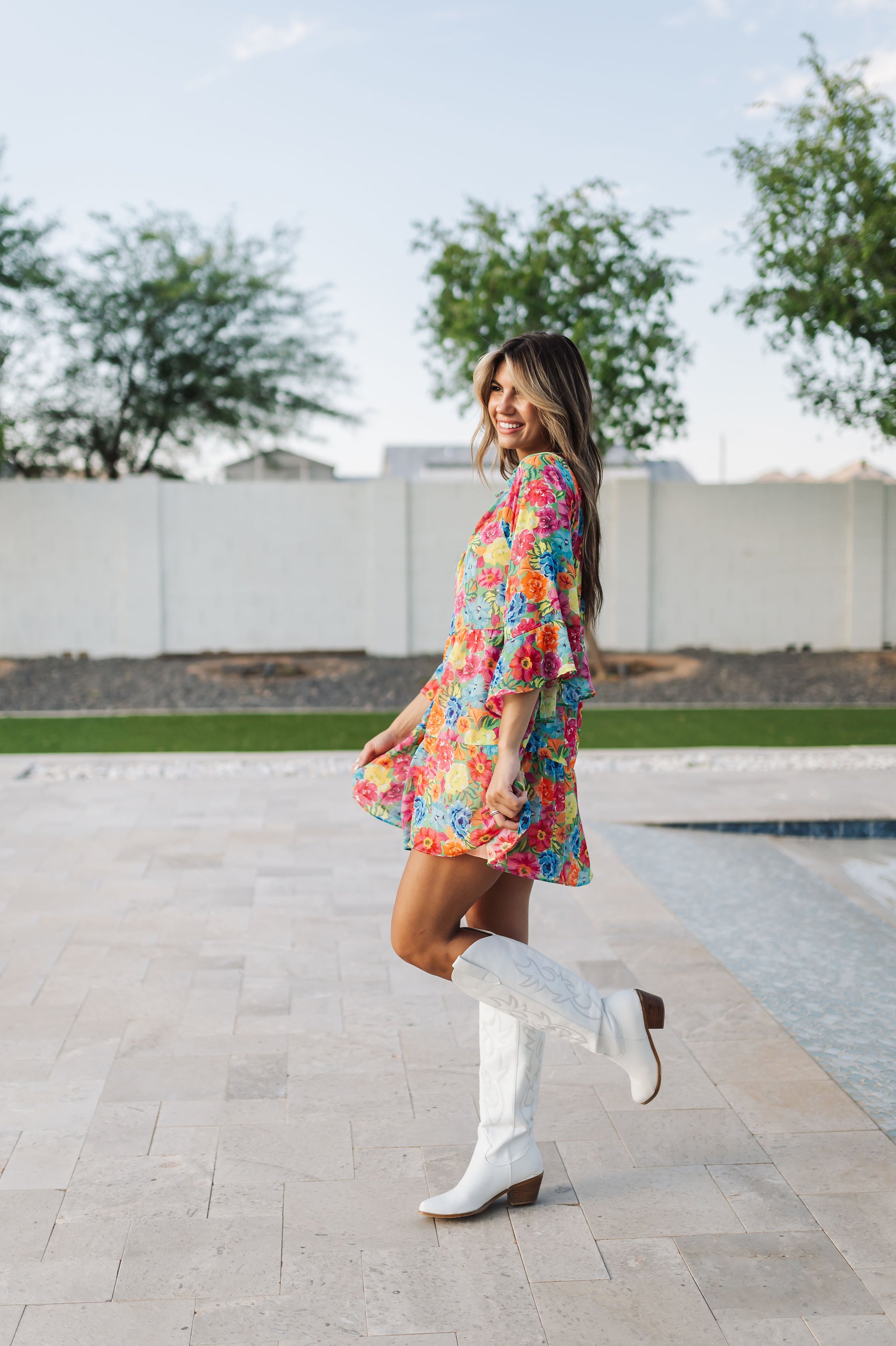 Side view of Viola Mini Dress with tiered skirt and ruffled 3/4 sleeves.