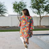 Rear view of Viola Mini Dress with tiered skirt and ruffled 3/4 sleeves.