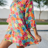 Close up view of Viola Mini Dress with tiered skirt, tie front detail, and ruffled 3/4 sleeves.