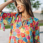 Close up view of Viola Mini Dress with tie front detail and ruffled 3/4 sleeves and neckline.