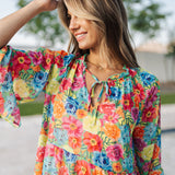 Close up view of Viola Mini Dress with tie front detail and ruffled 3/4 sleeves and neckline.