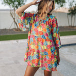 Front view of Viola Mini Dress with tiered skirt, tie front detail, and ruffled 3/4 sleeves