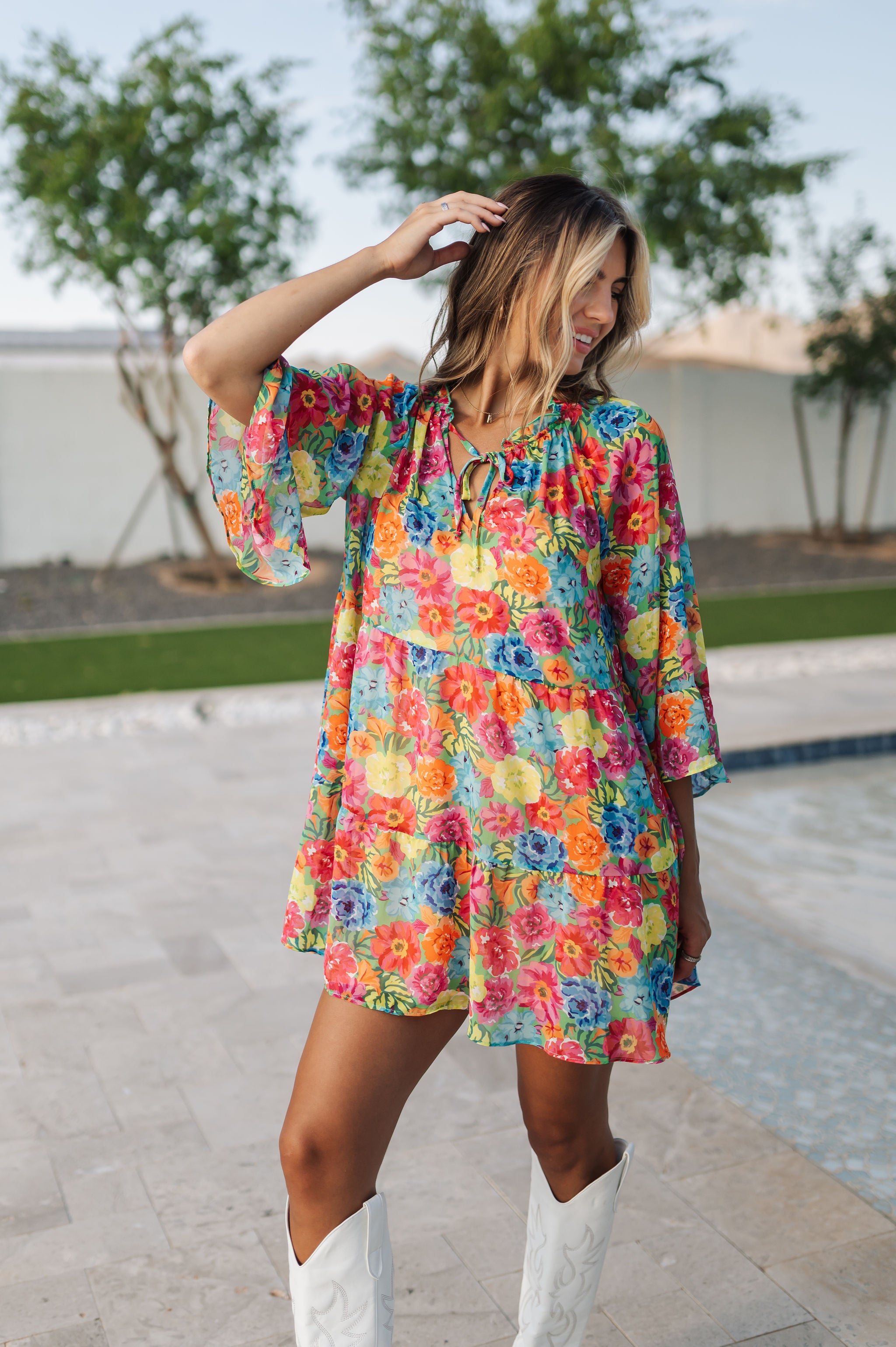 Front view of Viola Mini Dress with tiered skirt, tie front detail, and ruffled 3/4 sleeves