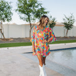 Front view of Viola Mini Dress with tiered skirt, tie front detail, and ruffled 3/4 sleeves.