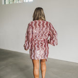 Rear view of wrap Adeline Dress with long puff sleeves and allover zigzag sequin pattern.