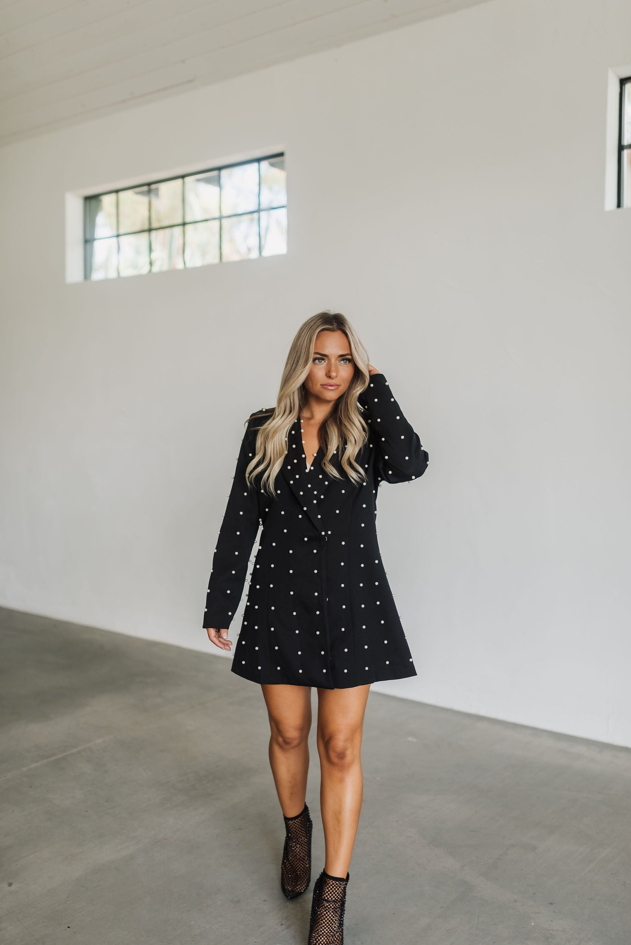 Front view of black long sleeve Riley Blazer Dress with lapel collar and allover pearl detail. 