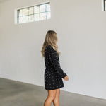 Side view of black long sleeve Riley Blazer Dress with allover pearl detail. 