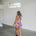 Rear view of Elisabeth Romper with allover abstract print, flowy mini skirt, and wide straps.