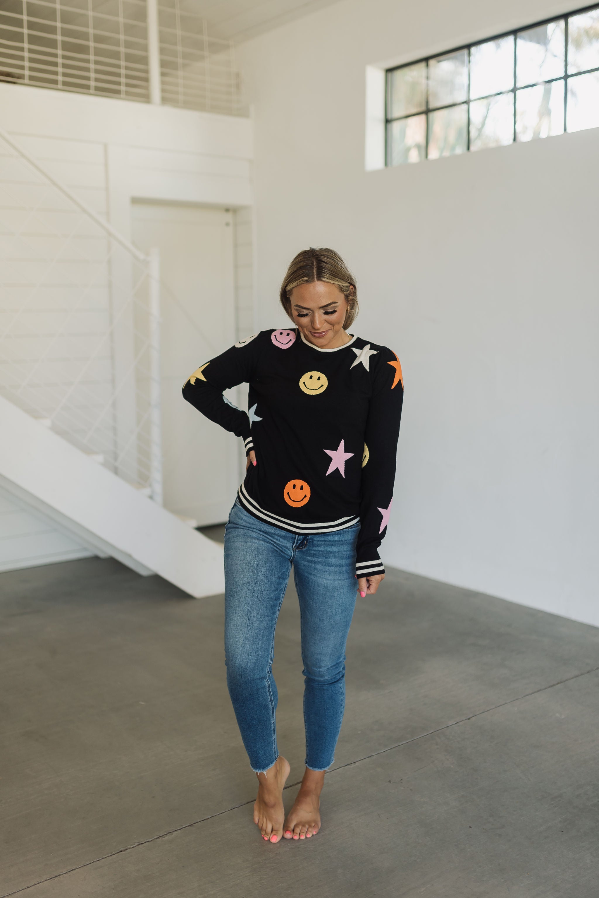 Front view of Stars And Smiles Sweater with allover stars and smile polka dot pattern. 