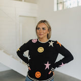 Front view of Stars And Smiles Sweater with allover stars and smile polka dot pattern. 