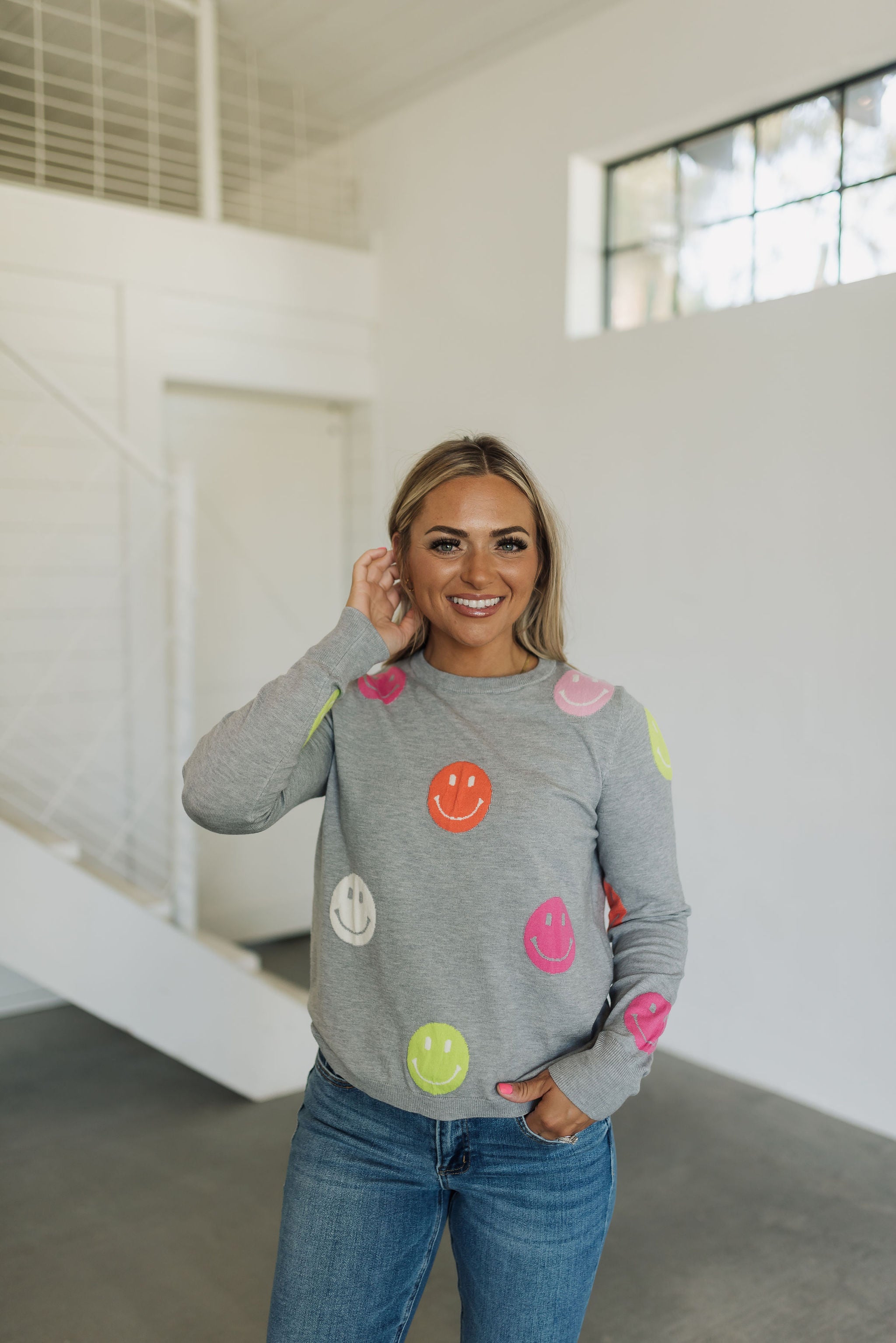 Front view of All Smiles Sweater with allover smile polka dot pattern.
