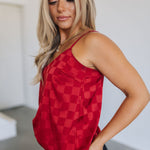 Side view of Spotlight Tank with spaghetti straps and allover red checkered satin print. 