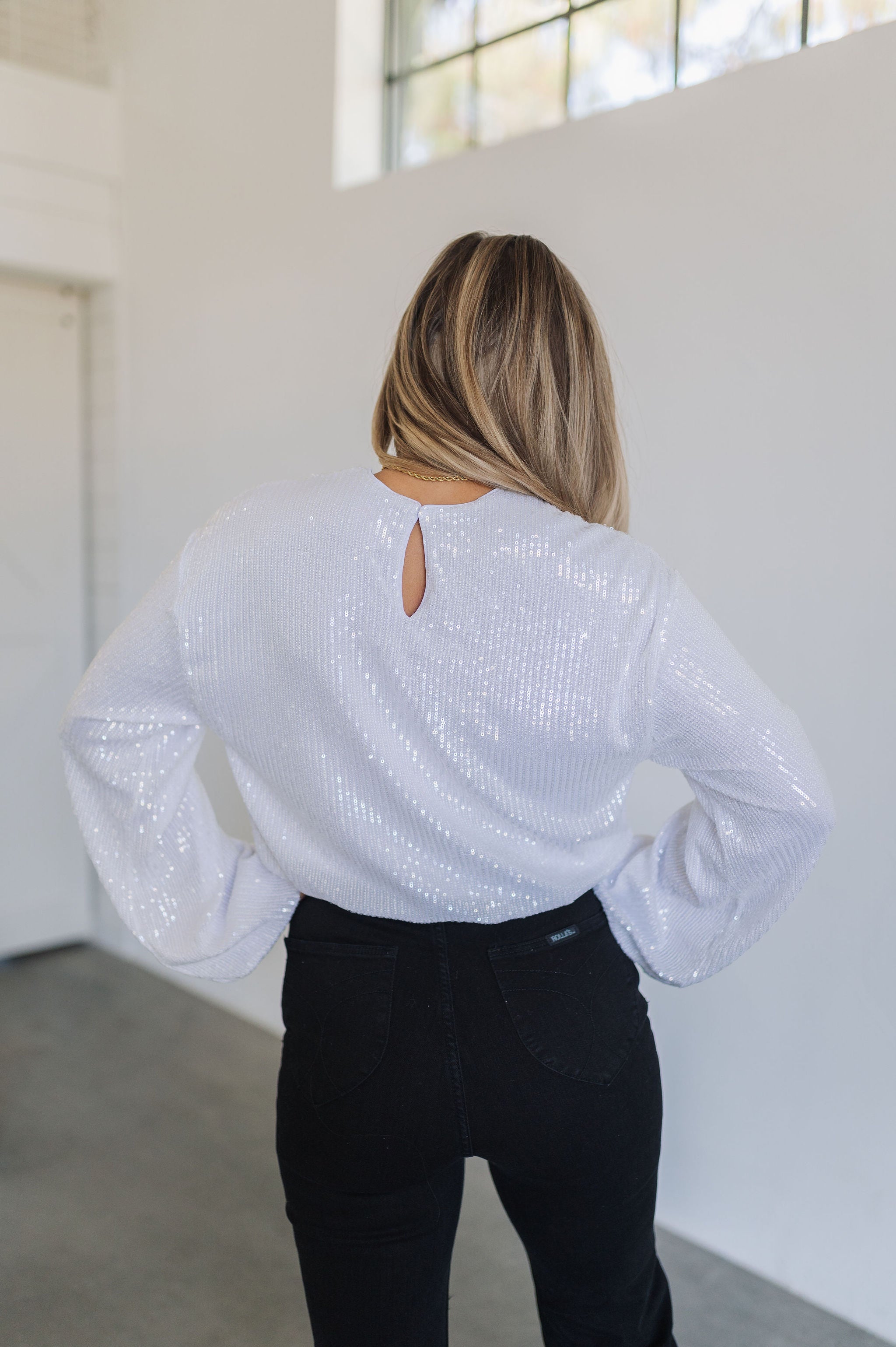 Up close rear view of East Coast Flare jeans in black corduroy with angled rear pockets.