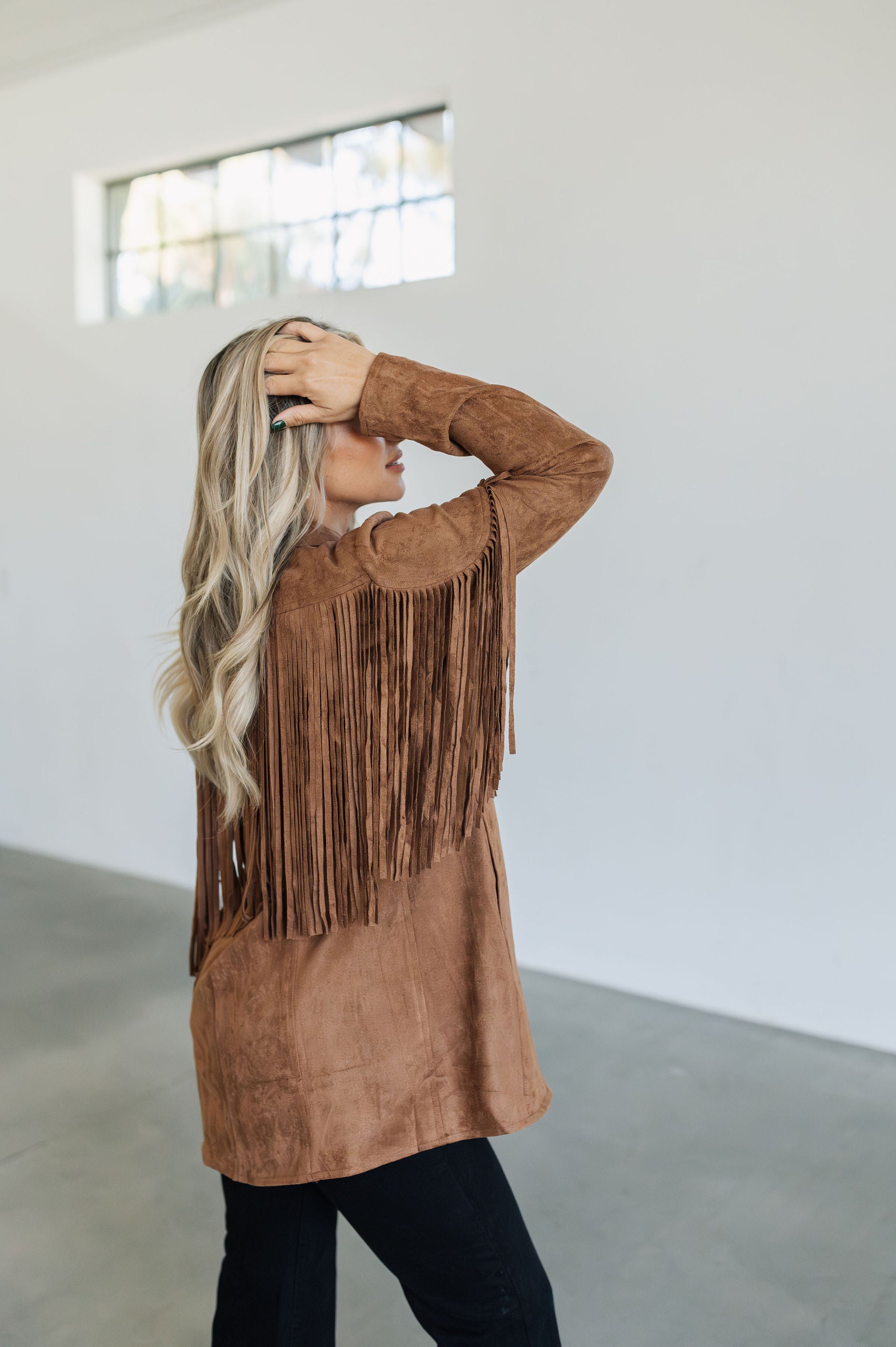 Side view of Dutton Fringe Suede Jacket in cocoa with fringe detailing at chest and arms.  