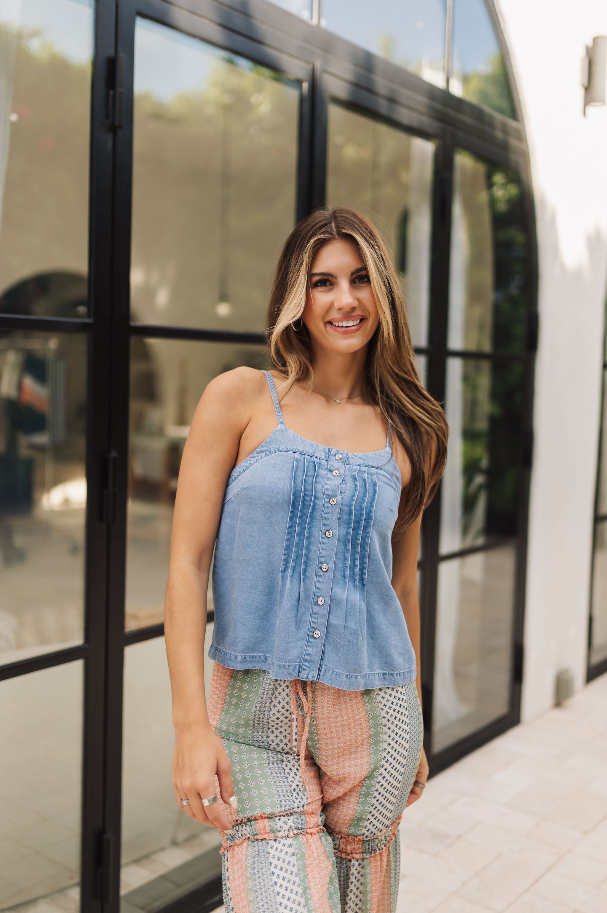 Front view of Blue Ridge Button Down Chambray Tank in blue denim with thin straps, button-down front, and pin tuck  details.