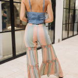 Rear view of Prairie Sunset Bell-Bottoms with wide legs, tiered ruffle details, and allover country print. 