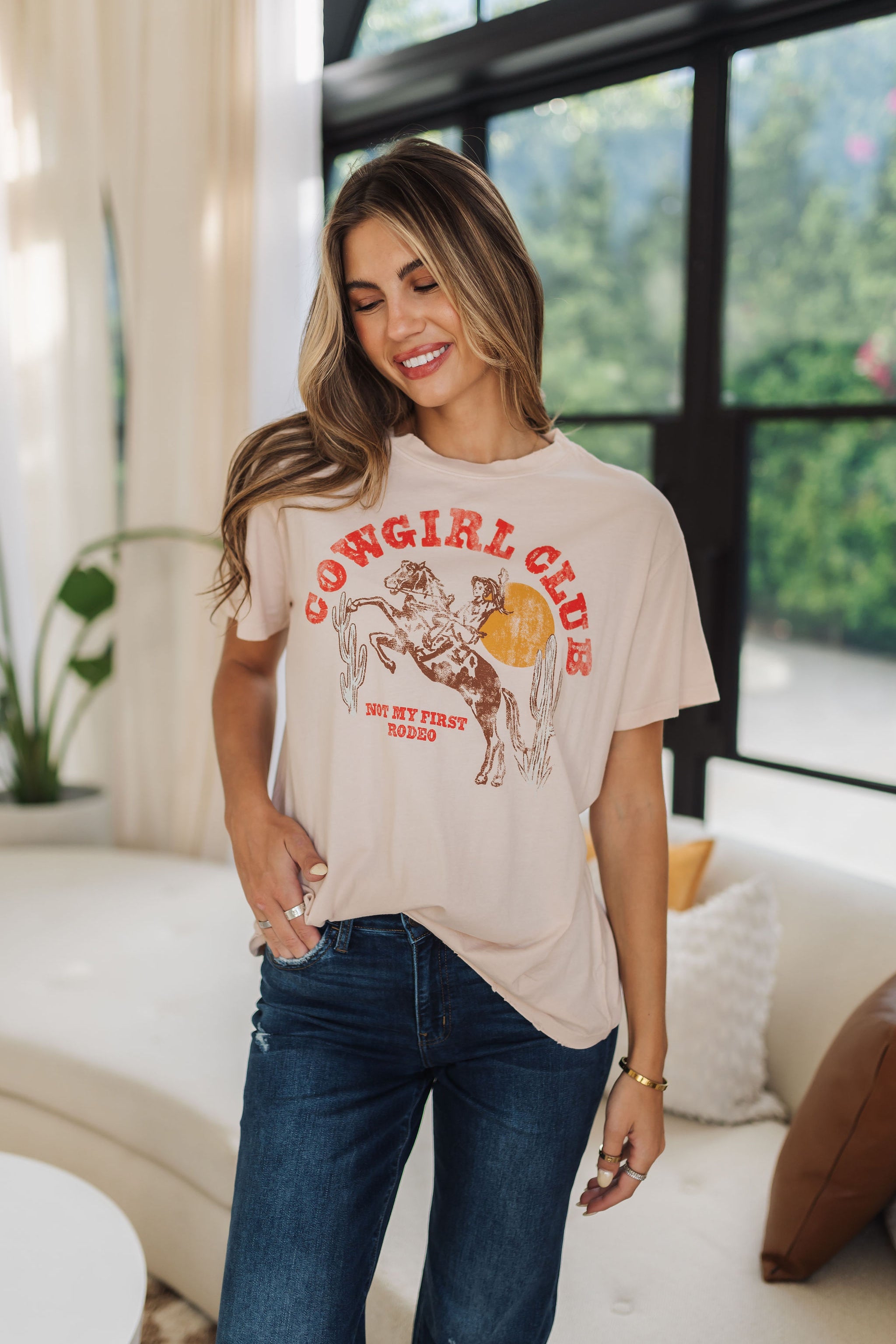 Front view of Travis Tee Distressed with "Cowgirl Club" graphic and relaxed fit. 