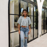  Front view of Whispering Willow Eyelet Top in faded sage color with eyelet details, scalloped edges and button front. 