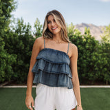 Front view of Ranchers Cascade Tank Top in blue denim color, thin straps, tiered ruffles. 