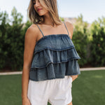 Front view of Ranchers Cascade Tank Top in blue denim color, thin straps, tiered ruffles. 