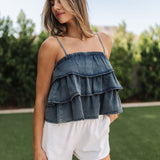 Front view of Ranchers Cascade Tank Top in blue denim color, thin straps, tiered ruffles. 