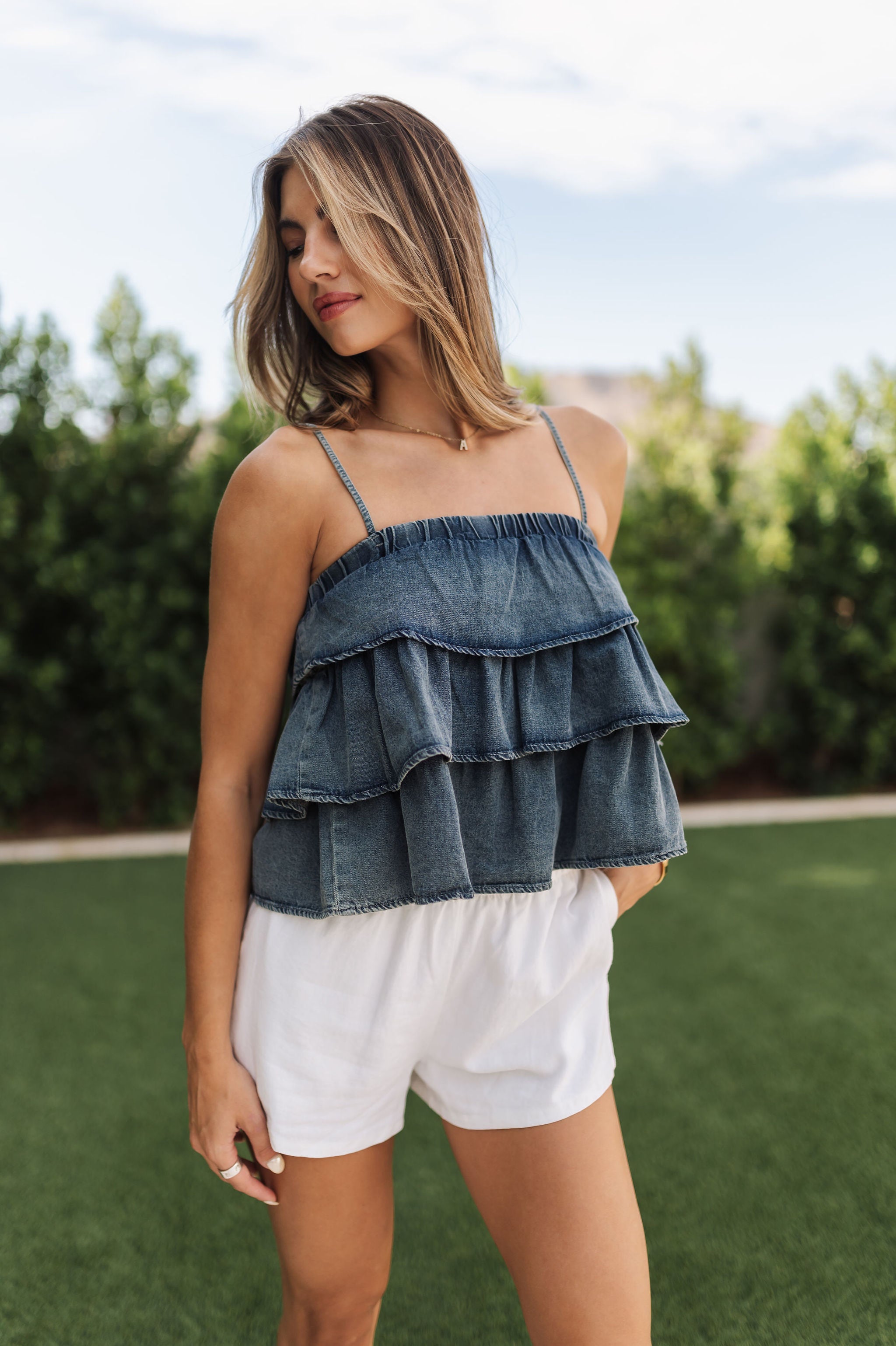 Front view of Ranchers Cascade Tank Top in blue denim color, thin straps, tiered ruffles. 