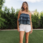 Front view of Ranchers Cascade Tank Top in blue denim color, thin straps, tiered ruffles. 