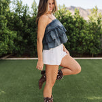 Side view of Ranchers Cascade Tank Top in blue denim color, thin straps, tiered ruffles. 