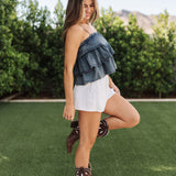 Side view of Ranchers Cascade Tank Top in blue denim color, thin straps, tiered ruffles. 