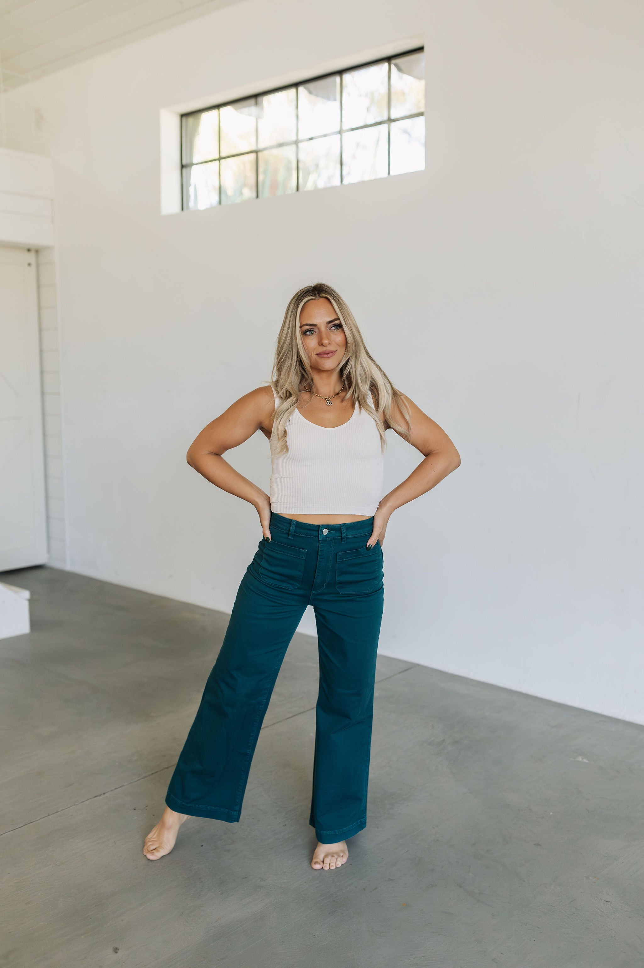 Front view of wide leg Sailor Jeans in forest with sailor style patch front pockets. 