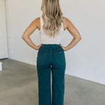 Rear view of wide leg Sailor Jeans in forest with angled rear pockets. 