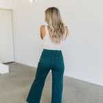Rear view of wide leg Sailor Jeans in forest with angled rear pockets.