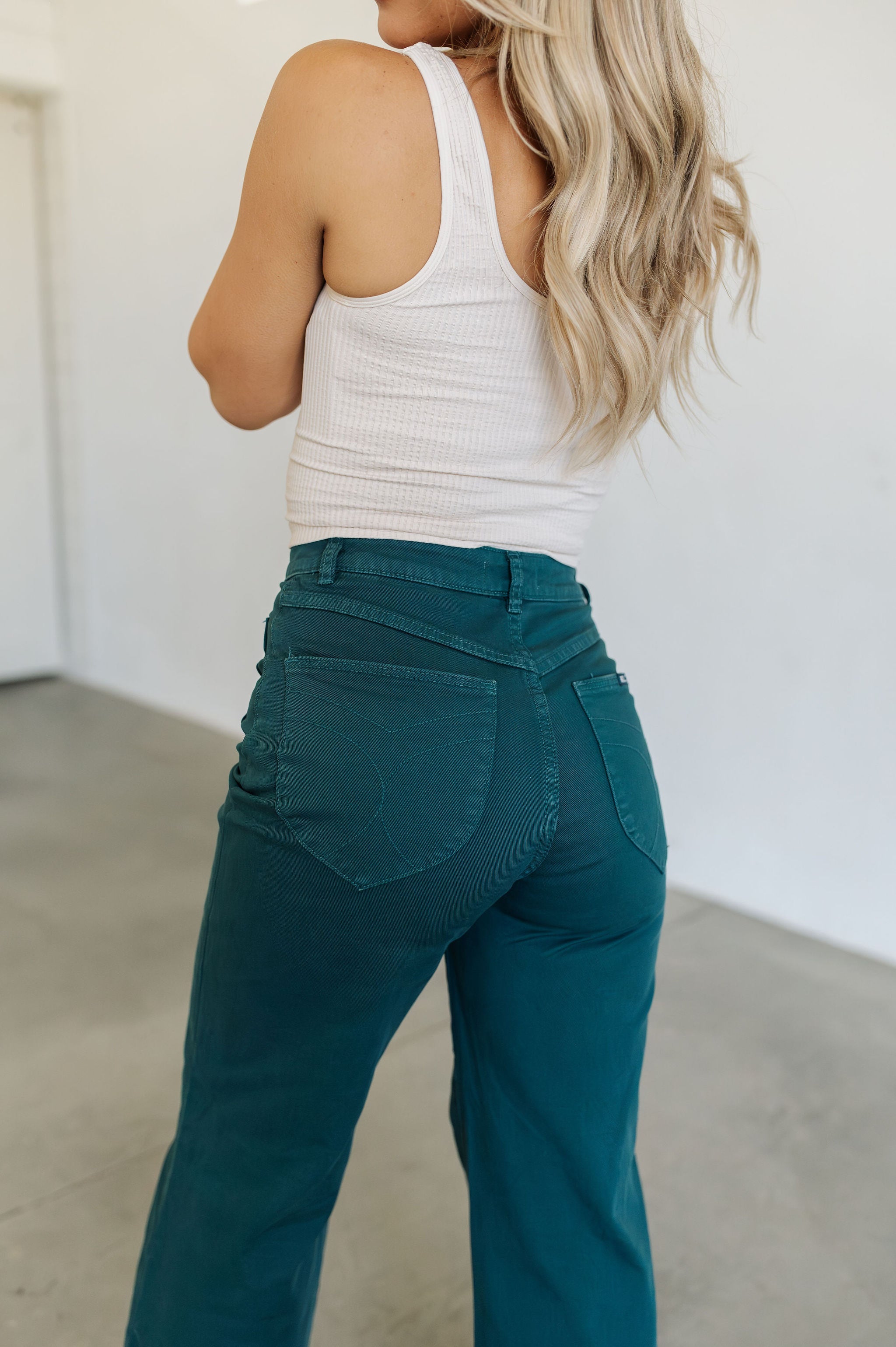 Rear view of Sailor Jeans in forest with angled rear pockets.