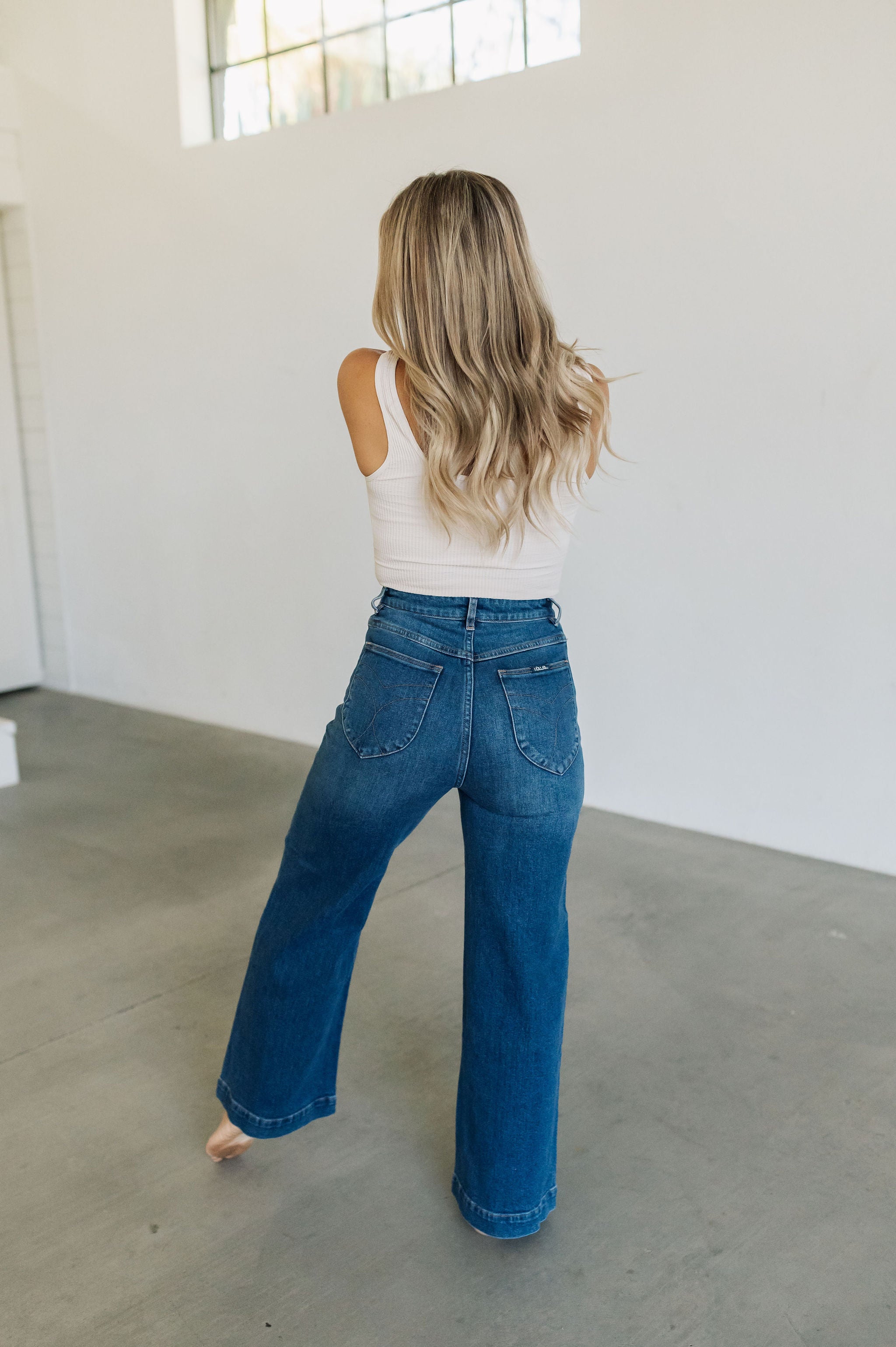 Rear view of wide leg Sailor Jeans in blue denim with angled rear pockets.