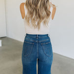 Rear of Sailor Jeans in blue denim with angled rear pockets.