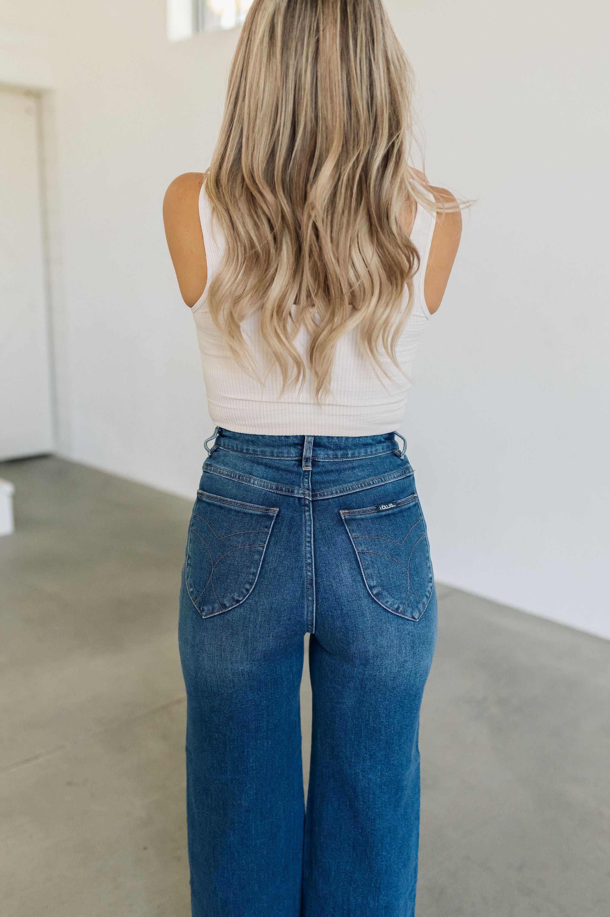 Rear of Sailor Jeans in blue denim with angled rear pockets.