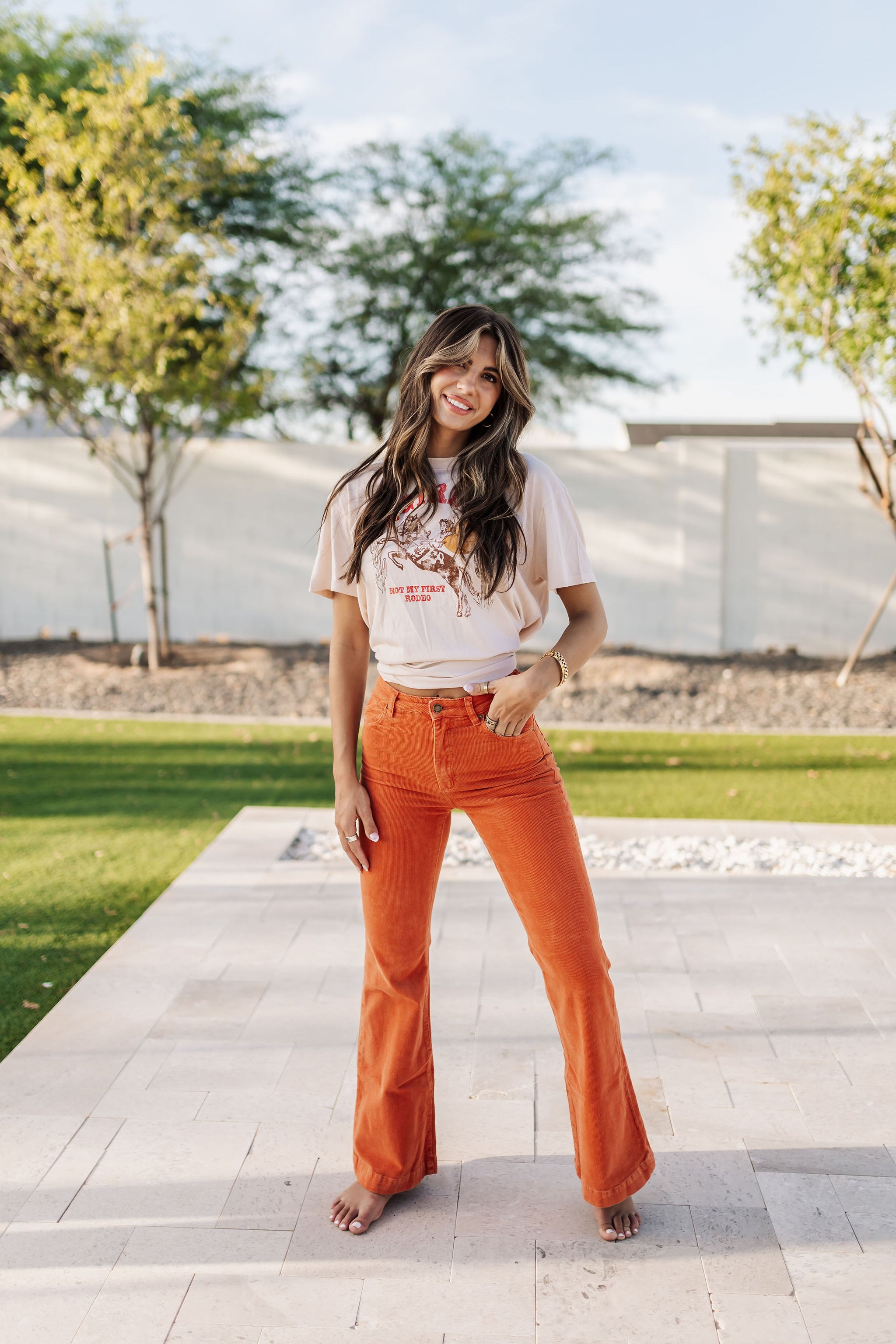 Front view of Eastcoast Flare Cord pants in a rust color and flared leg. 