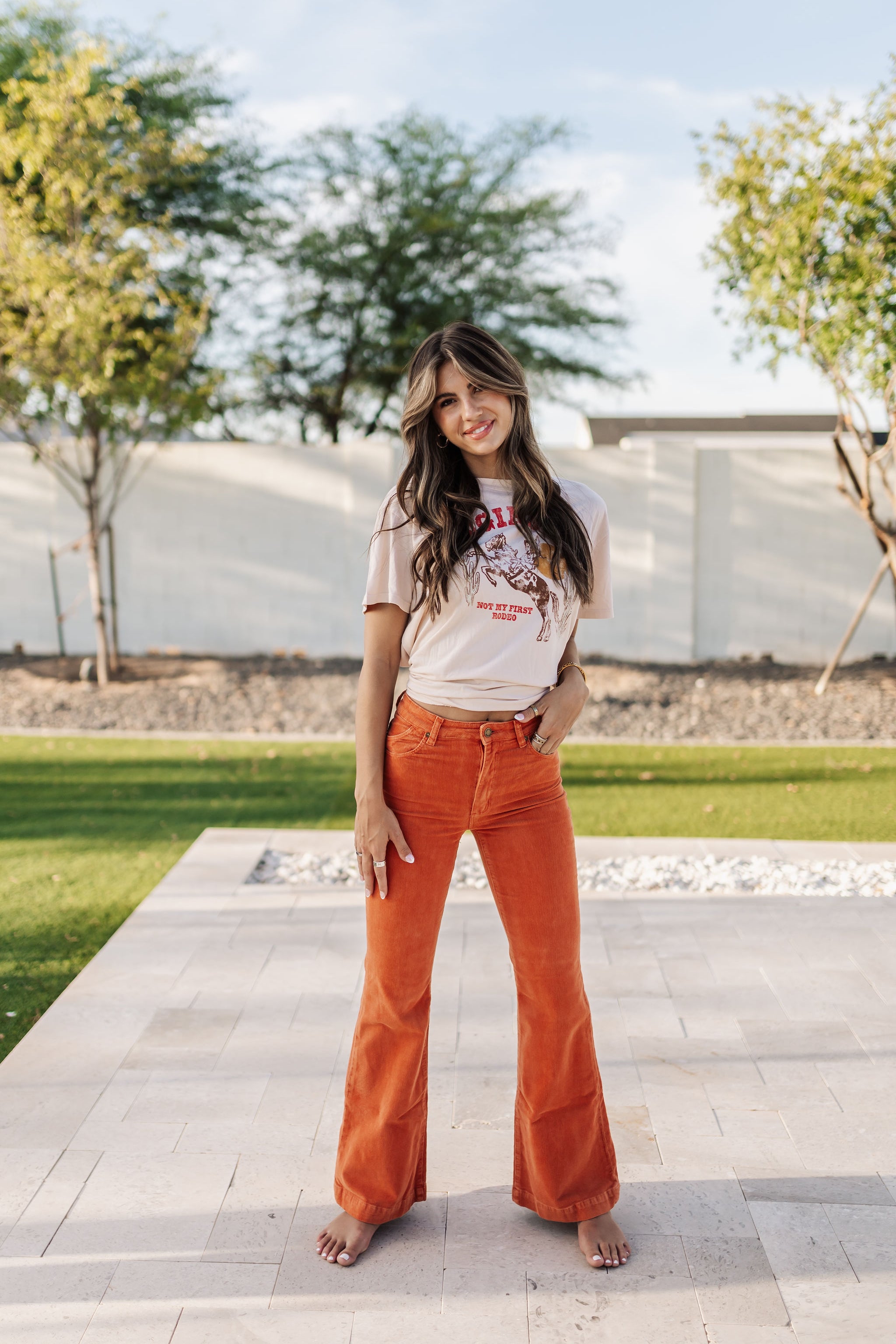 Front view of Eastcoast Flare Cord pants in a rust color and flared leg. 