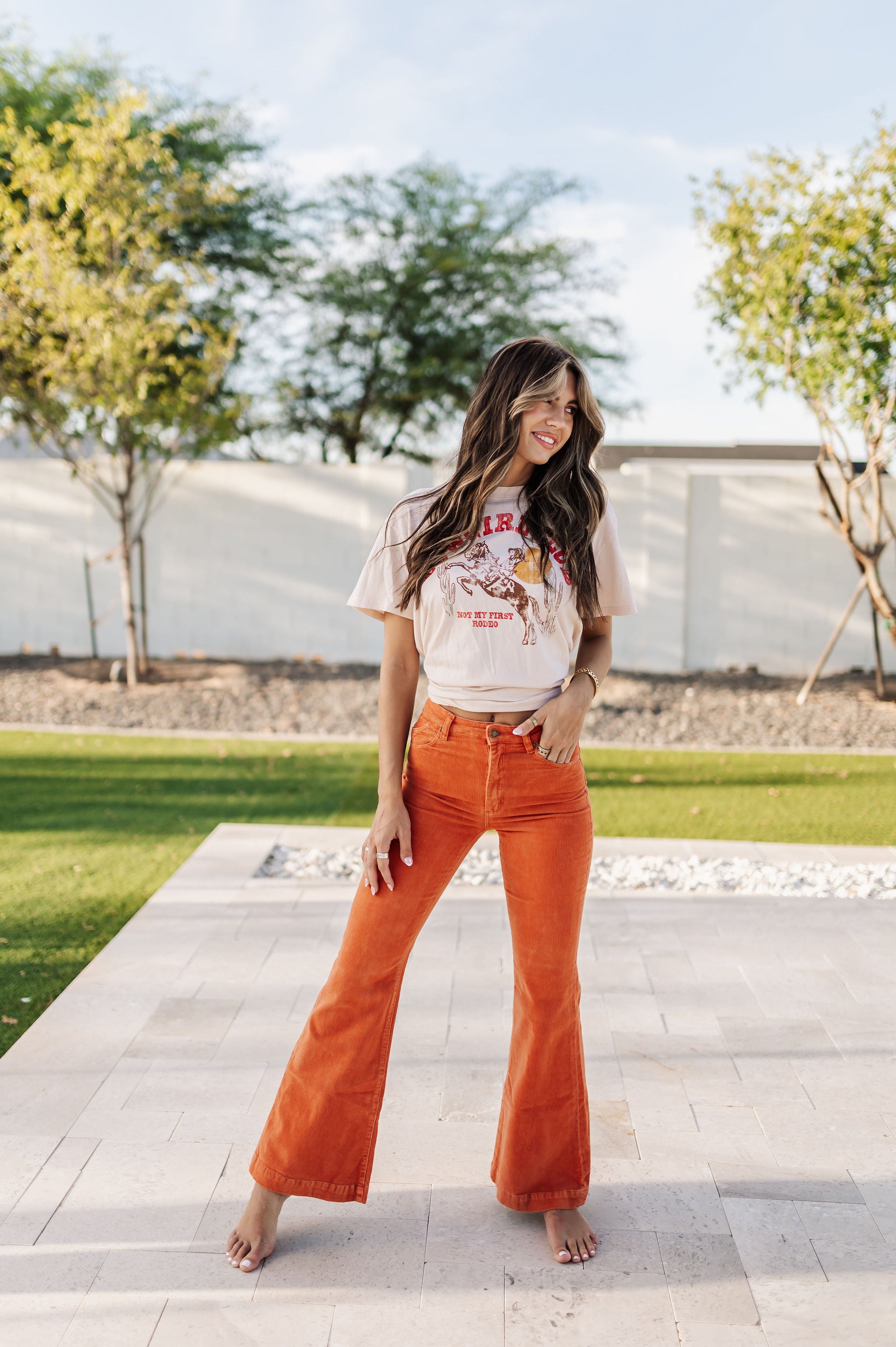 Front view of Eastcoast Flare Cord pants in a rust color and flared leg. 